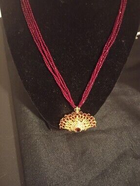 Source Unknown Gold Peacock Pendant with Deep Red Beaded Strands